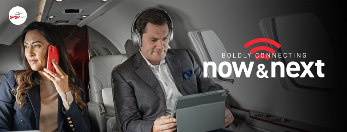 Image: Two business executives in flight utilizing network services with gogo business aviation technology. Headline: "Boldly connecting now & next" - "Gogo Business Aviation and Airshare Announce Multi-Year Agreement to Provide Upgraded Connectivity."