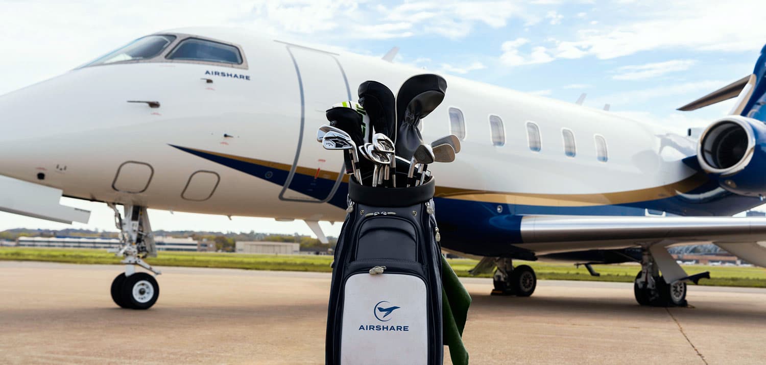 2025-KCBJ-Airshare+PGA A Challenger 3500 with the Airshare livery sits on an airport ramp with a PGA bag of golf clubs in front of it to show off the new partnership with Airshare and the PGA.